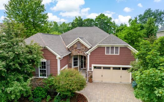 Brick two-story home in the Lake Minnetonka area with attached garage and landscaped front yard